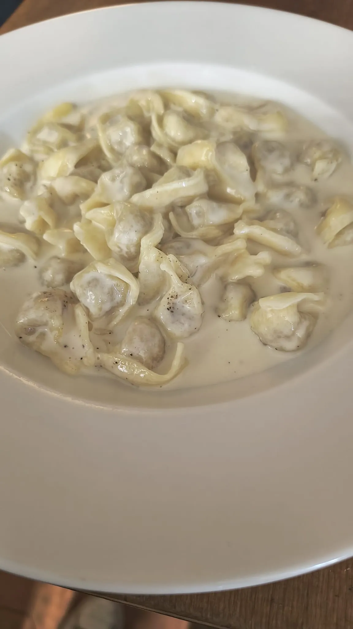 Un piatto fondo di tortelli in crema